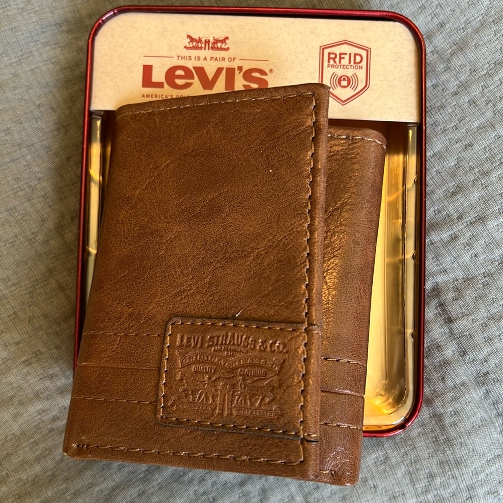 I believe real leather. Gift box has a small dent you can see in photo.